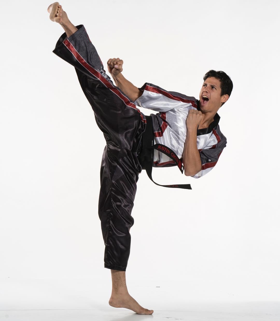 Justin Ortiz performing a high martial arts kick