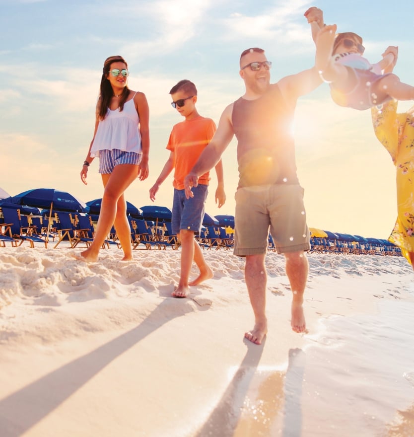 A family walking together on the beach at The Island Resort